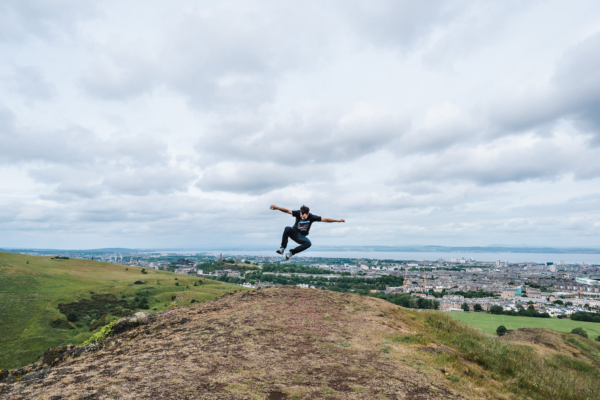 Scotland Wedding Photographer jumping at Arthur's Seat