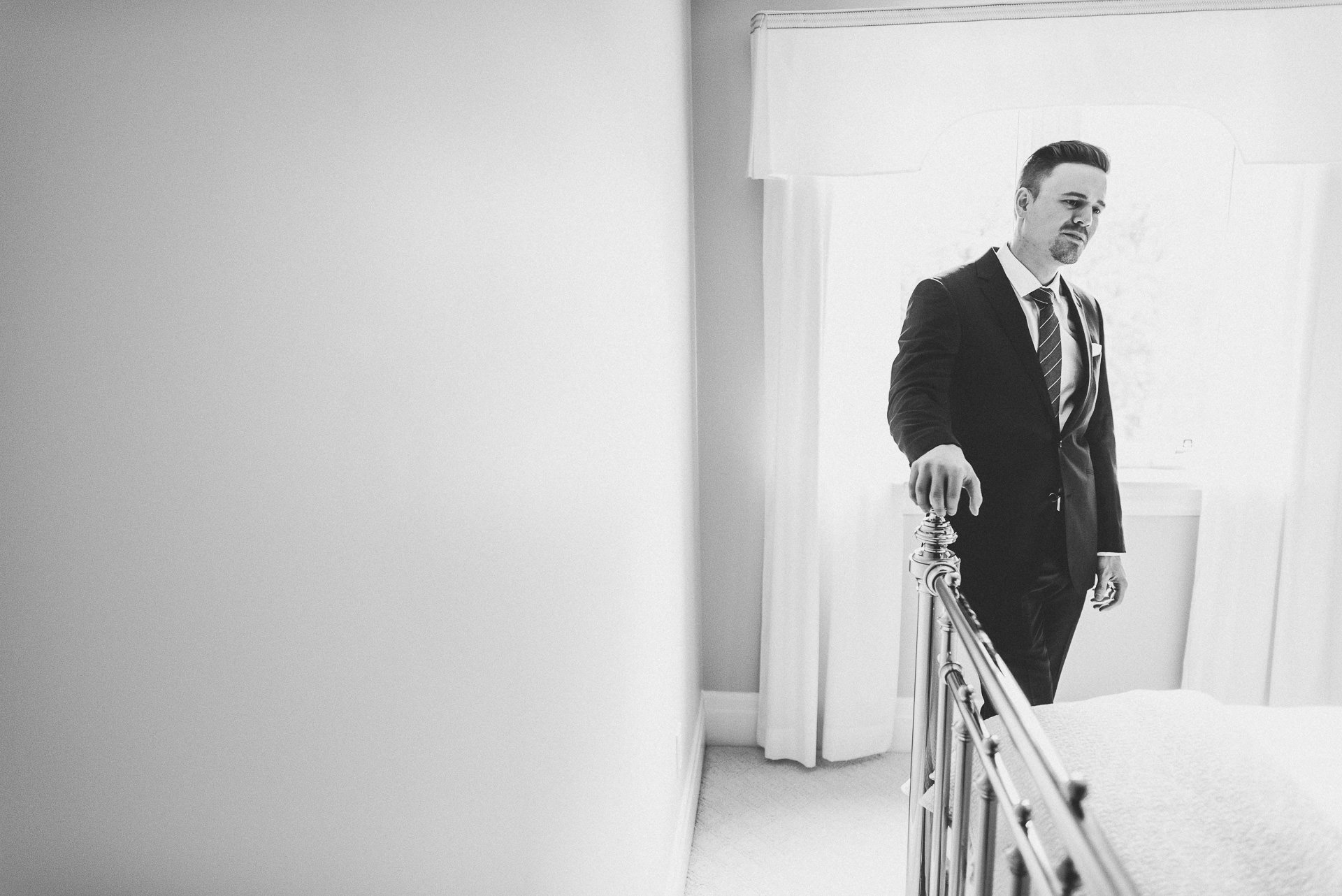 Brother watching sister get into wedding dress