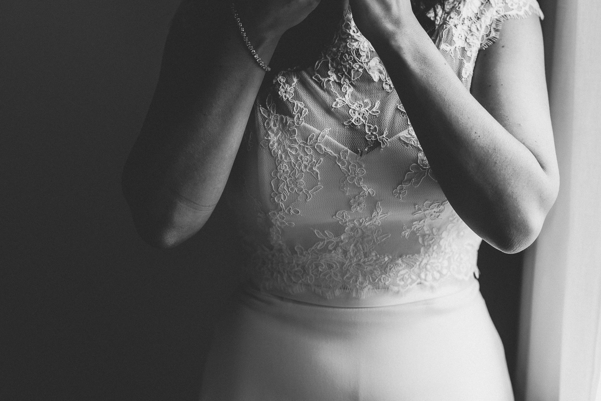 Bride putting on jewellery 