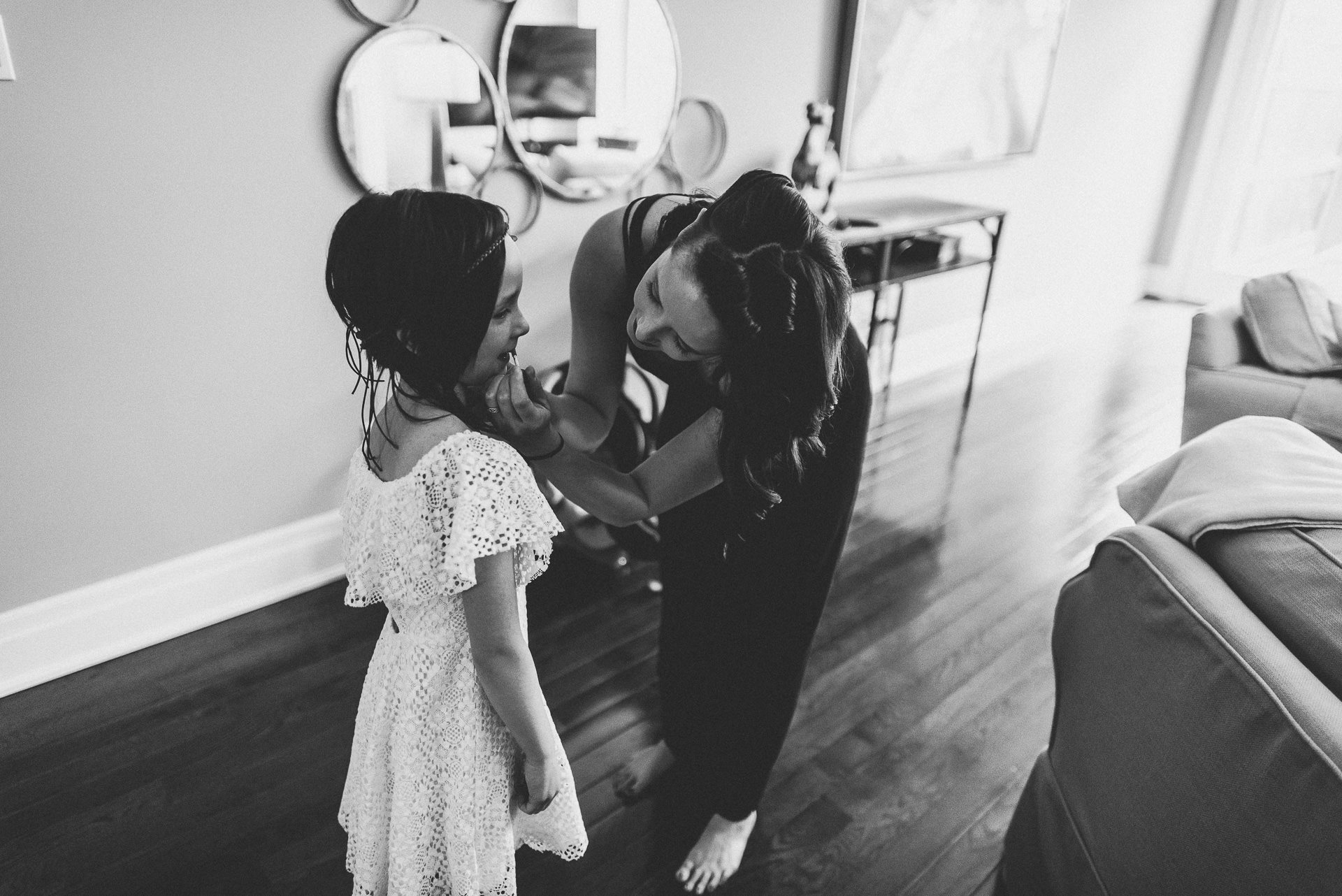 girl having lipstick applied at wedding