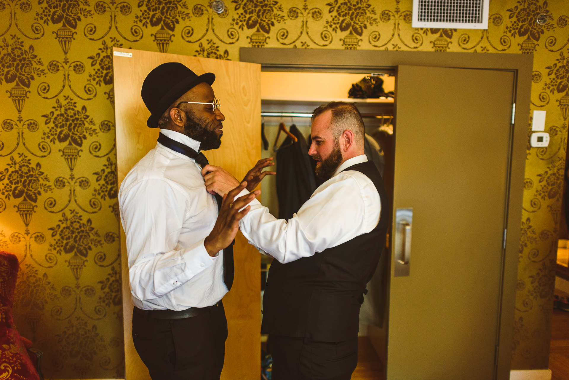 groomsmen putting on suits