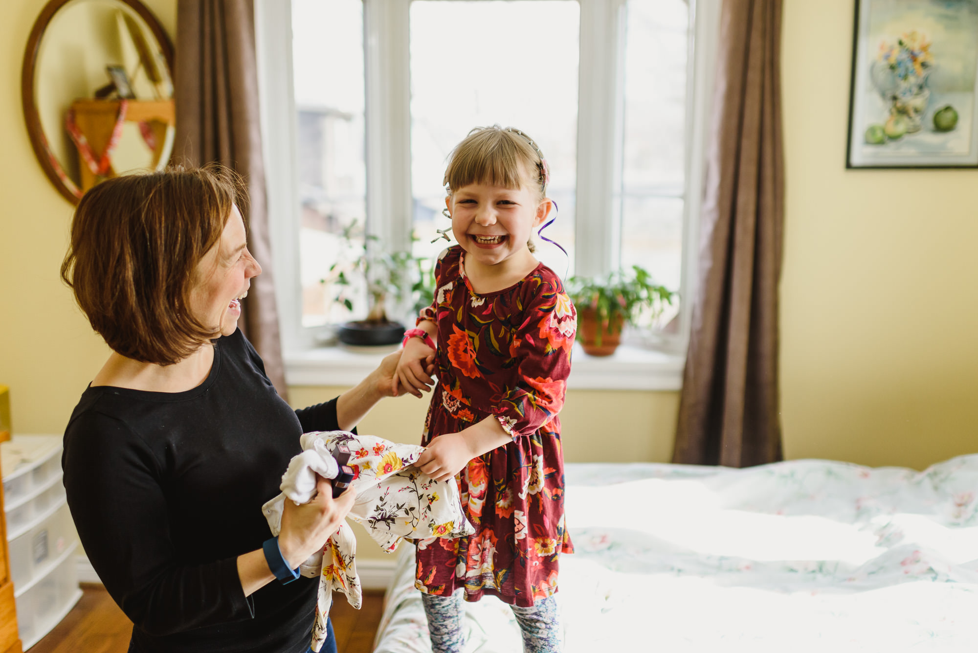 Kid jumping on bed for Documentary Hamilton Family Photographer