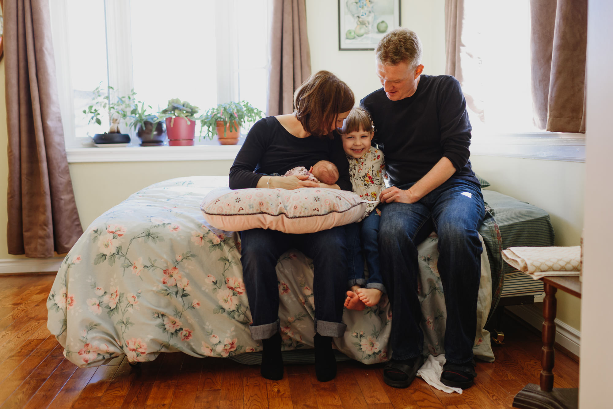 Family watching newborn during Documentary Hamilton Family Photographer