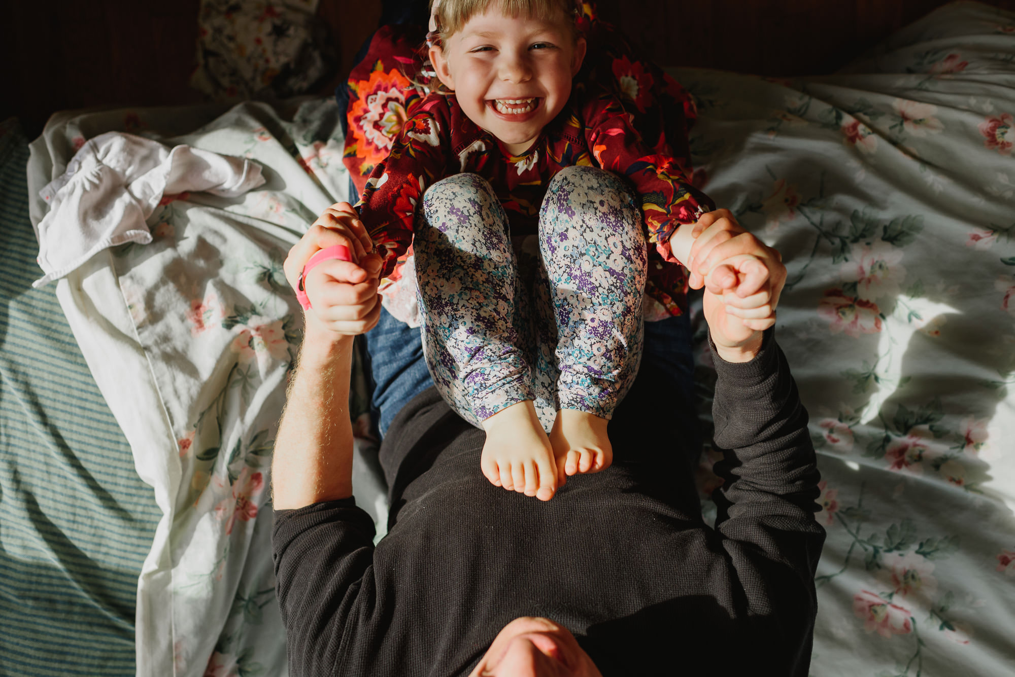 Daughter and Dad playing on bedside